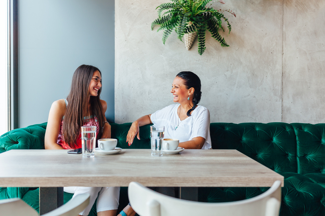Two Women Talking In Cafe